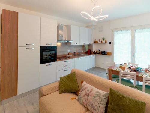 a living room with a couch and a kitchen at Assisi valley - Modern Apartment with Covered Parking in Bastia Umbra