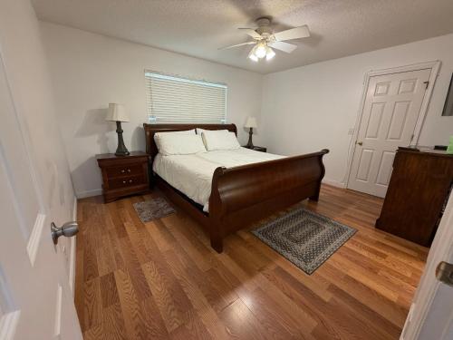 a bedroom with a bed and a ceiling fan at House 210 Brunswick in Brunswick