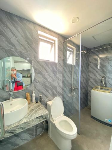 a bathroom with a toilet and a sink and a mirror at Thien Khanh Hotel for rent in Danang
