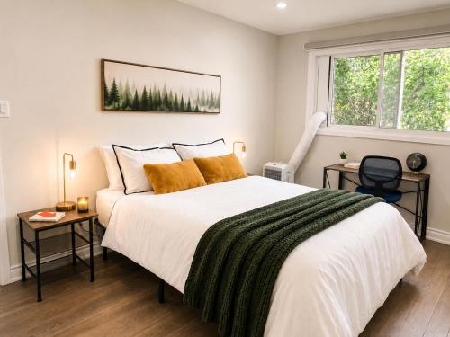 a bedroom with a large bed and a window at Lux 5BR Spacious Home Near Yonge St in Newmarket