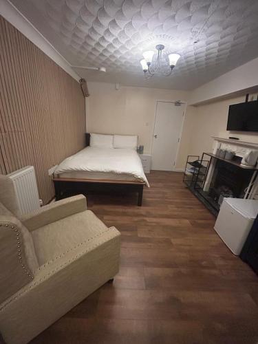 a living room with a bed and a couch at Hawkins Guesthouse in Milton