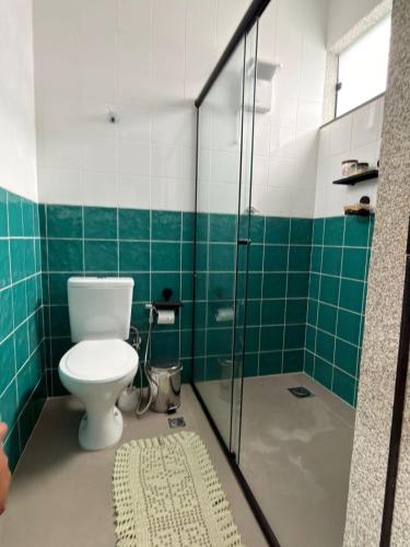 a bathroom with a toilet and a glass shower at Hostel Casa do Sossego in Brasília