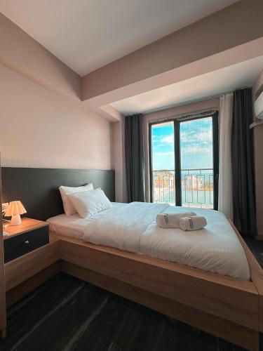 a bedroom with a large bed with a large window at Lemon Suites & Restaurant in Korucuk
