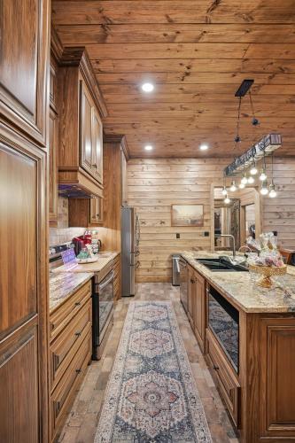 a kitchen with wooden walls and wooden cabinets and a counter at Raka Ranch Barndominium in Folsom