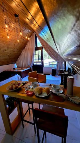 a table with plates of food on it in a room at Sombra do baú - Aurora in Timbe do Sul