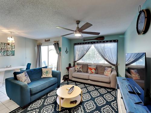 a living room with two couches and a table at Island Home 102 in Destin