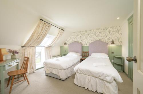 a bedroom with two beds and a window at Cardross Holiday Cottages in Arnprior