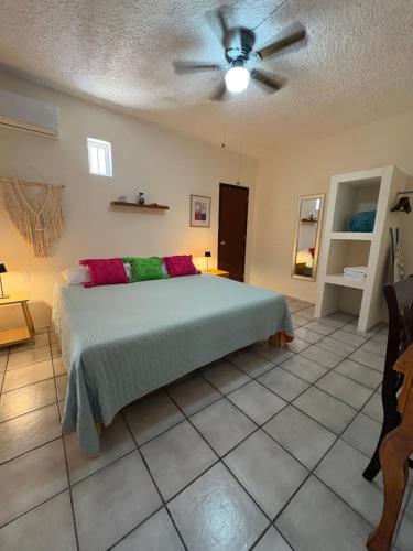 a bedroom with a bed and a ceiling fan at Casa Jardín in Tequila