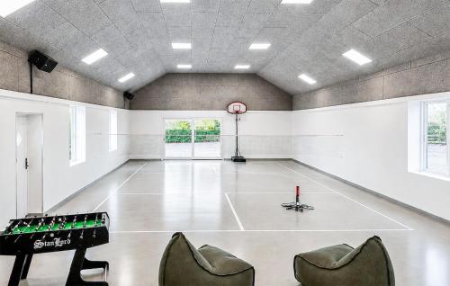 a gym with a ping pong table and chairs at Nice Home In Hadsund With Sauna in Hadsund