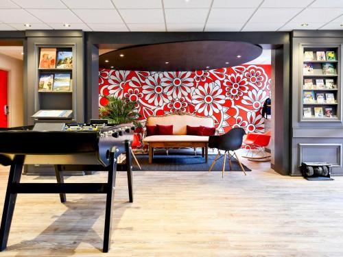 a store with a red and white floral wall at ibis Quimper in Quimper