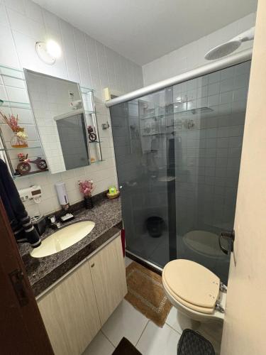 a bathroom with a shower and a sink and a toilet at Flat Monte Castelo Gravatá - Pe in Gravatá