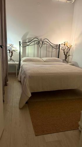 a bedroom with a bed with a metal frame at Mama’s house in Ágios Rókkos