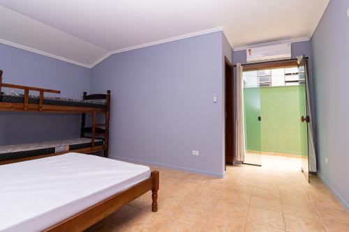 a bedroom with two bunk beds and a sliding glass door at Casa de praia Peruibe in Peruíbe