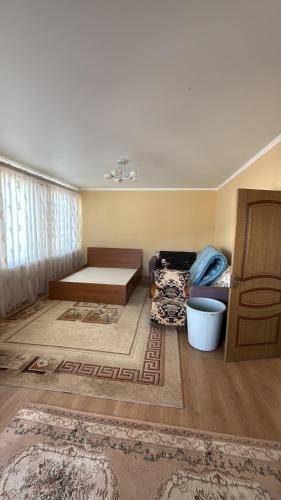 a living room with a bed and a couch at Берег in Bosteri