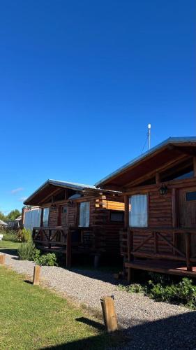 a log cabin building with windows on the side of it at Cabañas Punta Arena in San Pedro