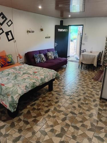a room with a bed and a couch and a table at Tereva home 2 in Bora Bora