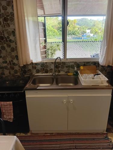 a kitchen with a sink and a window at Tereva home 2 in Bora Bora