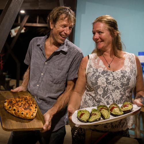 a man and a woman holding a tray of food at Carmen's place in Bastimentos