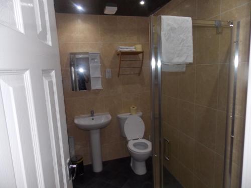 a bathroom with a toilet and a sink and a shower at The Trafford Hotel in Blackpool