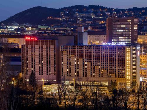 a view of a large building with lights on it at Mercure Budapest Castle Hill in Budapest