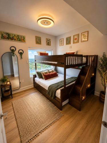 a bedroom with two bunk beds and a mirror at Golden Hour Penthouse - TideWater Beach Resort 2700 in Panama City Beach