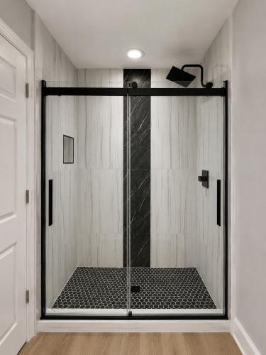 a shower with a glass door in a room at Golden Hour Penthouse - TideWater Beach Resort 2700 in Panama City Beach