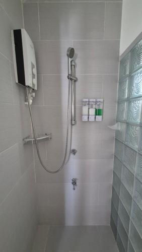 a bathroom with a shower with a shower at ClubBoracay Apartelle in Boracay