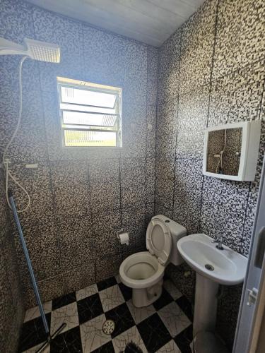 a bathroom with a toilet and a sink at Rancho da Benção in São Roque