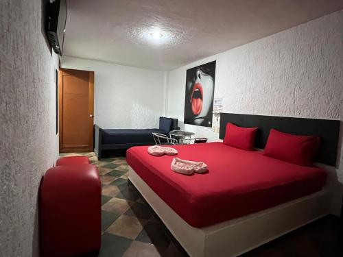 a bedroom with a red bed and a red suitcase at Hotel Boppard in Mexico City