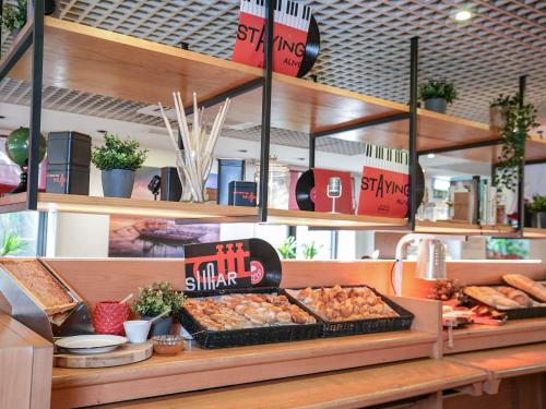 a bakery with a buffet of food on a counter at ibis Porto Centro São Bento in Porto