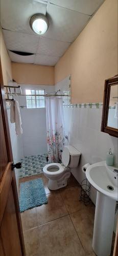 a bathroom with a toilet and a sink at Casa de Nivia in Acequias Abajo