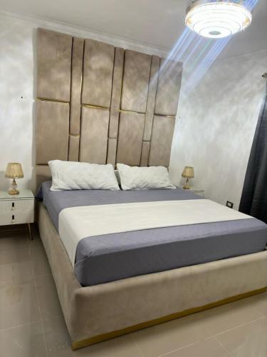 a bedroom with a large bed with a large headboard at Elegant and comfortable and exclusive first level in Santo Domingo