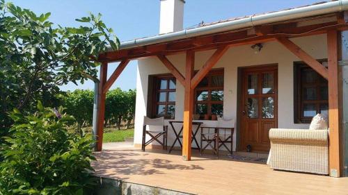 a patio with a wooden pergola next to a house at Remete-lak in Villány