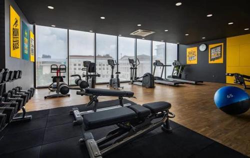 a gym with several treadmills and machines in a room at Manior PentStudio West Lake Accomadi in Hanoi