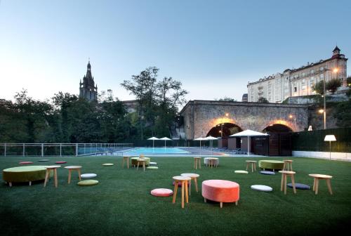 a group of tables and chairs on a field of grass at Occidental Bilbao in Bilbao