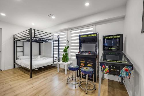 a bedroom with a bunk bed and two bar stools at Bunny Bliss - Upper Level HotTub FirePit Theatre in Langley