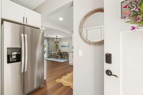 a kitchen with a stainless steel refrigerator and a dining room at Lakefront - Grill - Bunk Beds - Sleeps 6 in Akron