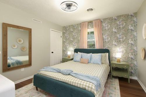 a bedroom with a bed with blue pillows and a mirror at Lakefront - Grill - Bunk Beds - Sleeps 6 in Akron