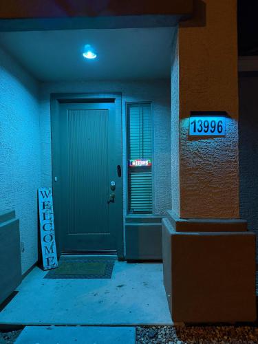 a blue door with a sign in front of it at Goodyear 2 Story Room 3 in Goodyear