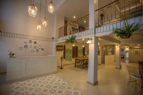 a large hallway with a table and chairs in a building at Vera Nidhra - Self check-in after 6pm in Bangkok