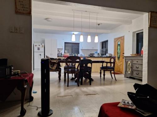 a kitchen and dining room with a table and chairs at Talipaea Lodge in Nuku‘alofa