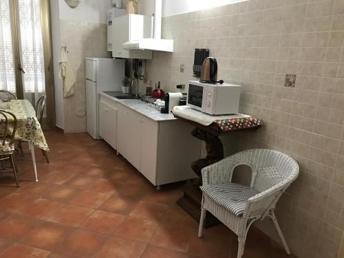 ミラノにあるSavona 91 Apartmentsのキッチン(電子レンジ、椅子付きのカウンター付)