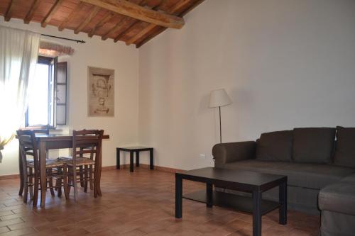 a living room with a couch and a table at Antico Borgo Casalappi in Campiglia Marittima