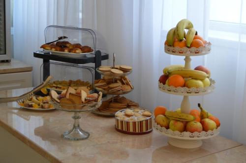 a bunch of different types of food on a counter at Hotel Bulevard Prestige in Slatina