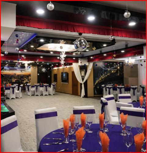 a banquet hall with a blue table and white chairs at Tsetsenkhangai Hotel in Ulaanbaatar