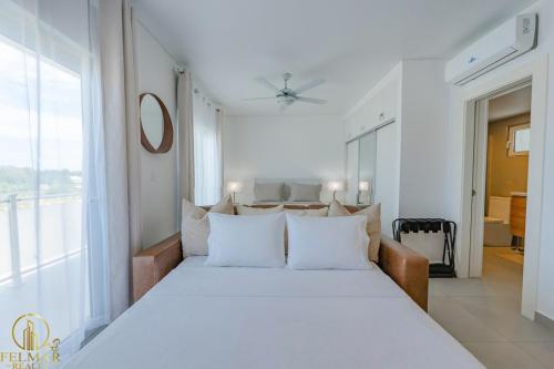 a bedroom with a large bed with white pillows at Aura Sosua Ocean Village in Sosúa