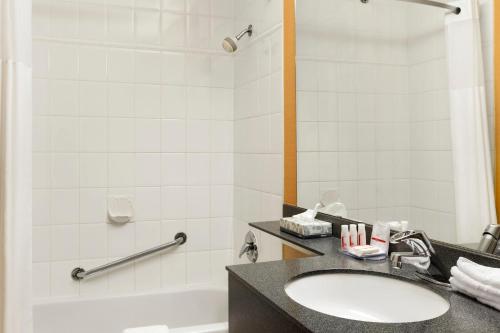 a bathroom with a sink and a tub at Days Inn by Wyndham Vancouver Downtown in Vancouver