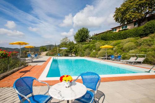 a table with flowers on it next to a swimming pool at Universal Harmony Agriturismo in Dicomano