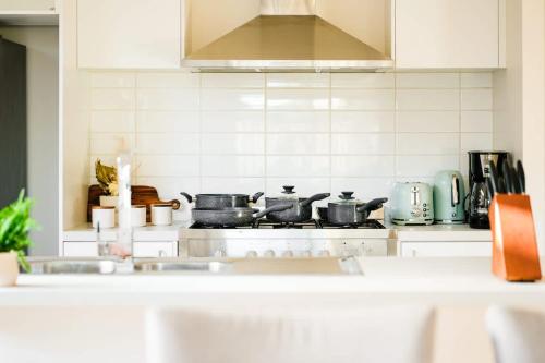 a kitchen with pots and pans on a stove at Seednest Stylish & Perfect for Relaxation in Melton South