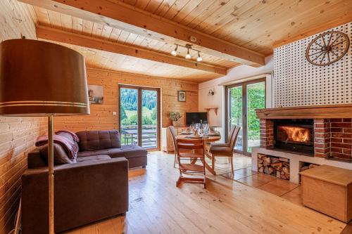 a living room with a couch and a fireplace at Kraševec Lodge with Garden & Pool - Happy Rentals in Velike Bloke